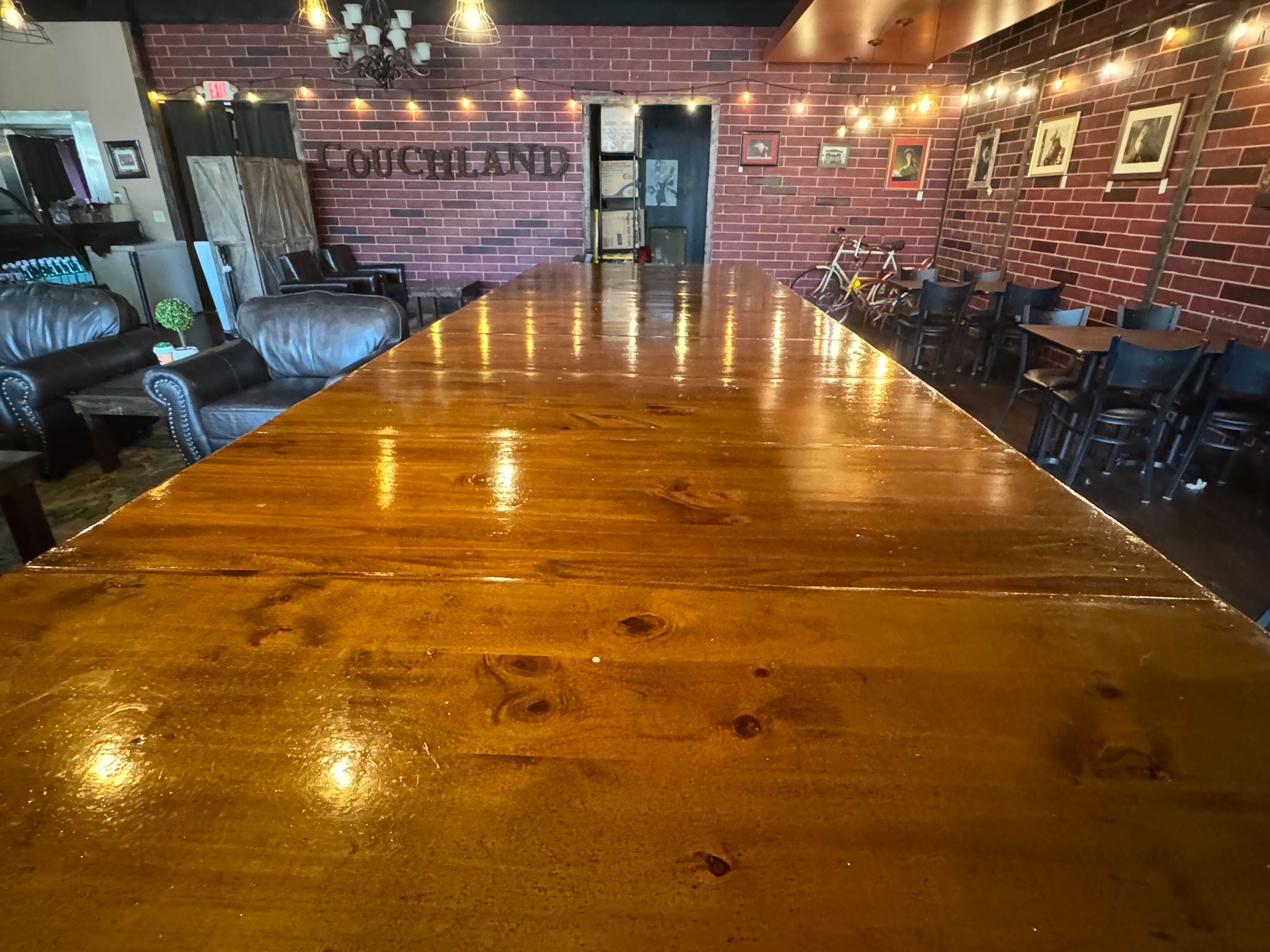 The bar seating area with a wooden high-top